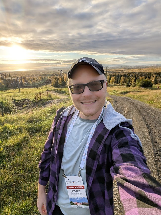 Steven on a scenic hillside at sunset