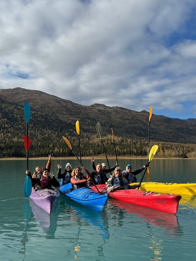 Kayaking group on vivid blue water in Alaska